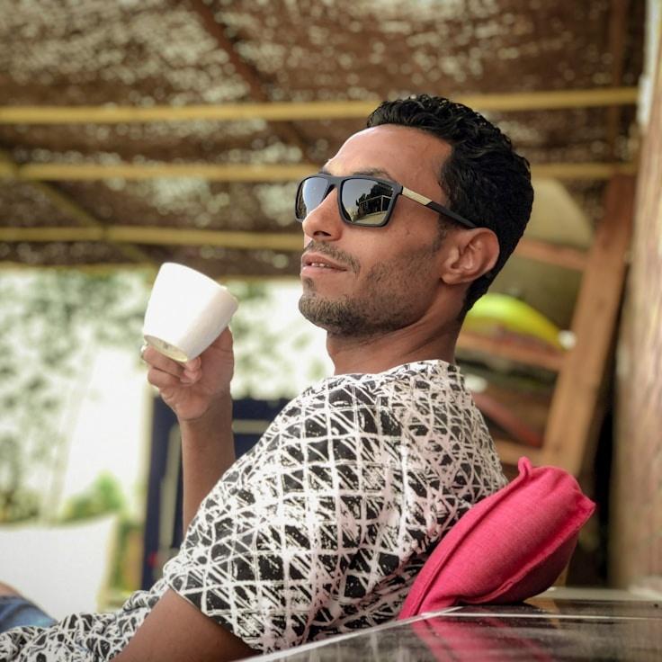 Priya Desai, Lead Design Curator at Quill Garden Studio, reviewing corporate floral arrangements